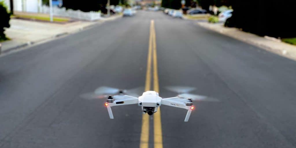 A drone flying low in the street for our Drone Division