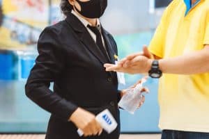 Healthcare Security officer sanitising visitors